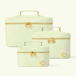 Set of three light green beauty cases with gold zippers on a white background - Love Boo UK